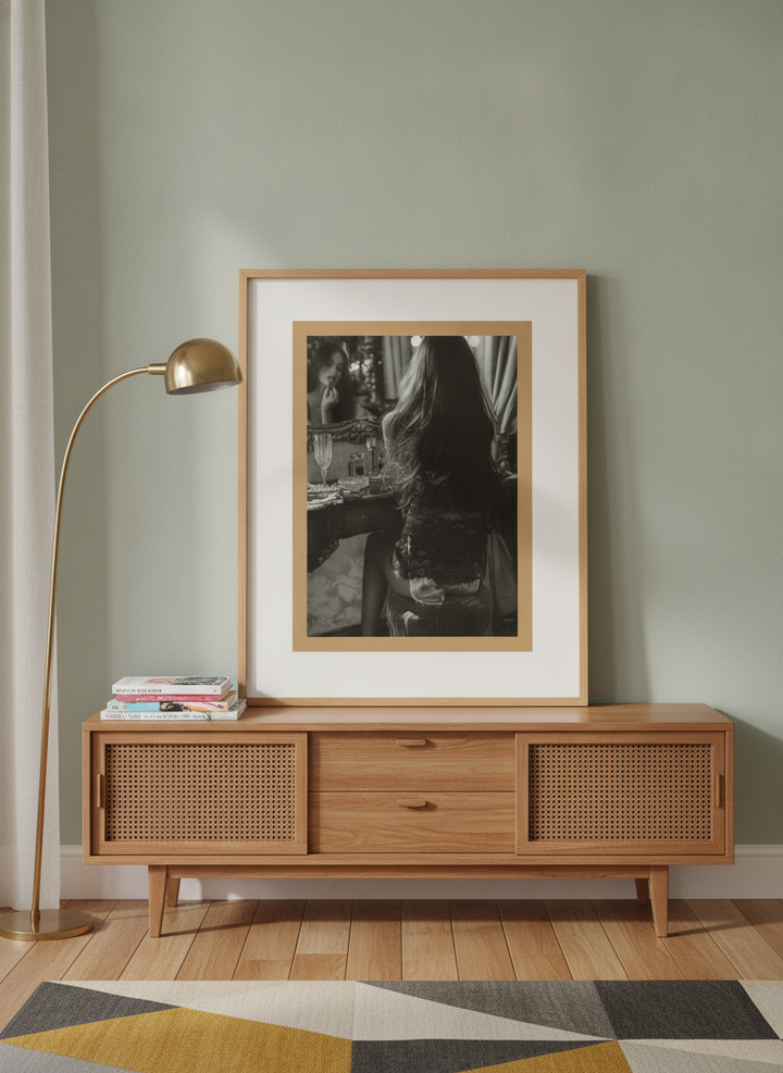 Modern wall art print standing on a sideboard in a mid-century living room