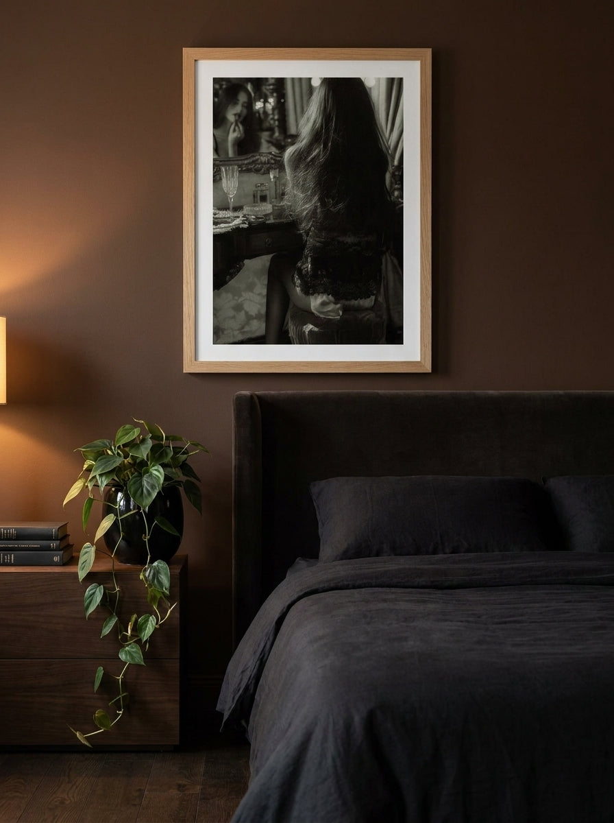 Modern wall art print styled on the wall in a moody bedroom
