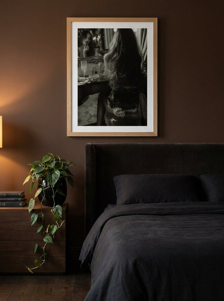Modern wall art print styled on the wall in a moody bedroom