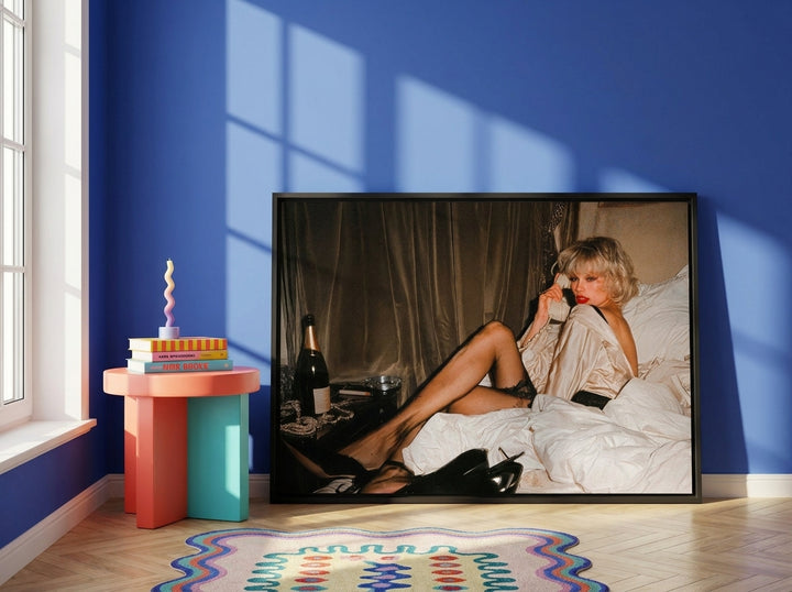 Canvas wall art with a black surround leaning against the wall in a colourful eclectic dining room
