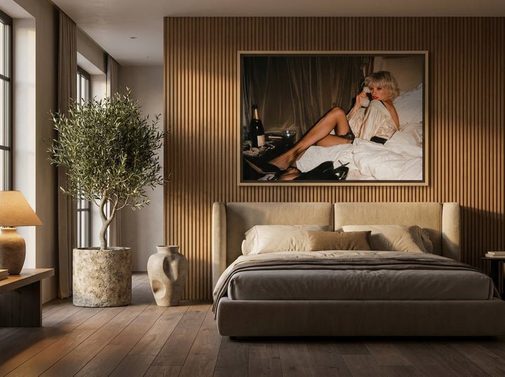 Oversized statement canvas wall art with a natural timber surround styled on the wall in a luxe bedroom