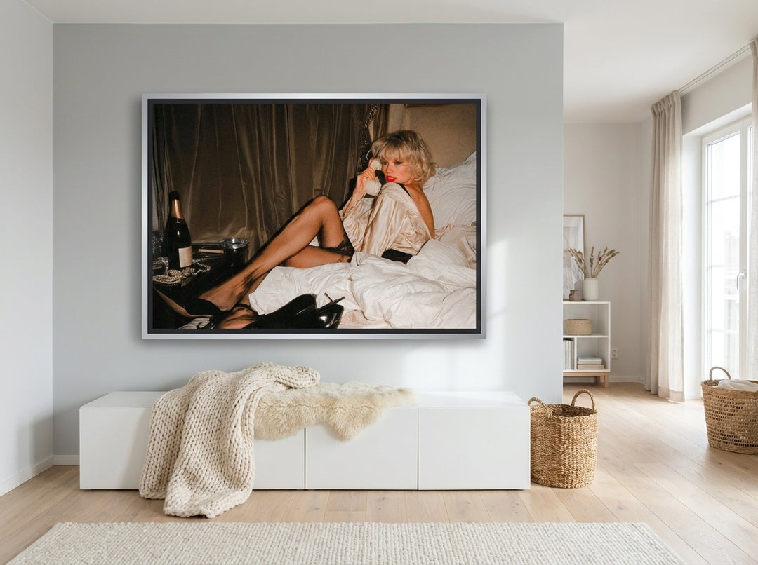 Oversized statement canvas wall art with a silver leaf surround styled on the wall in a bright Scandinavian living room
