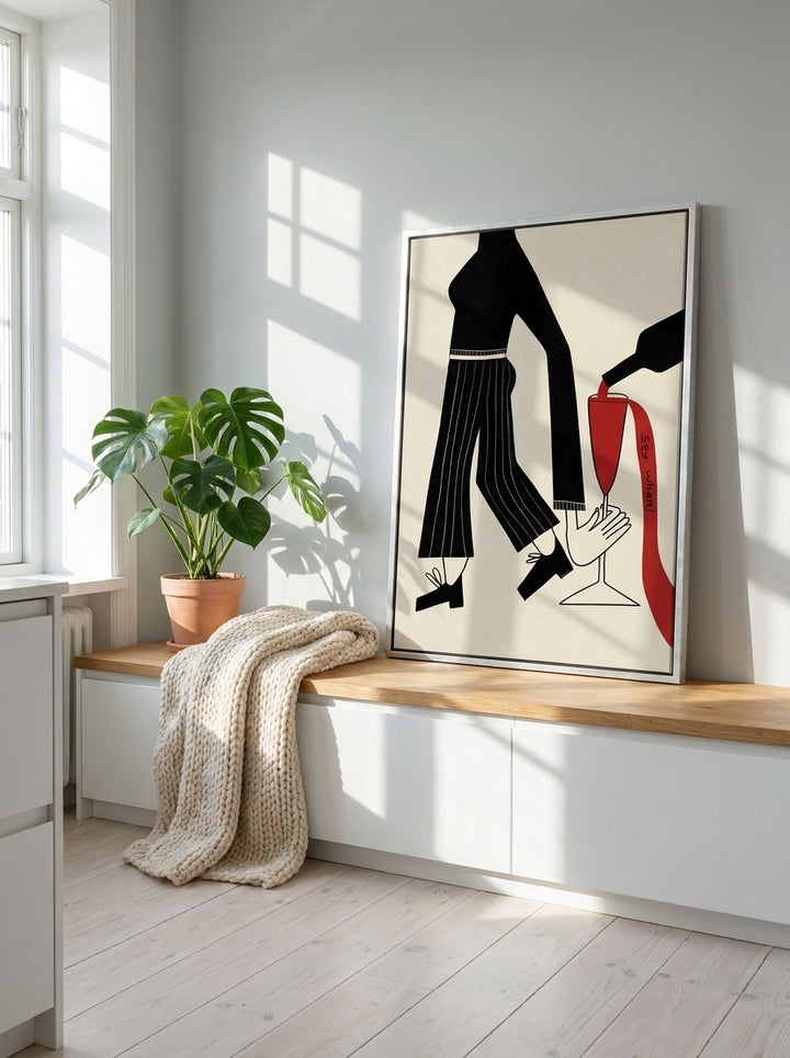 Canvas wall art with a silver leaf surround standing on a kitchen bench in a bright Scandinavian kitchen