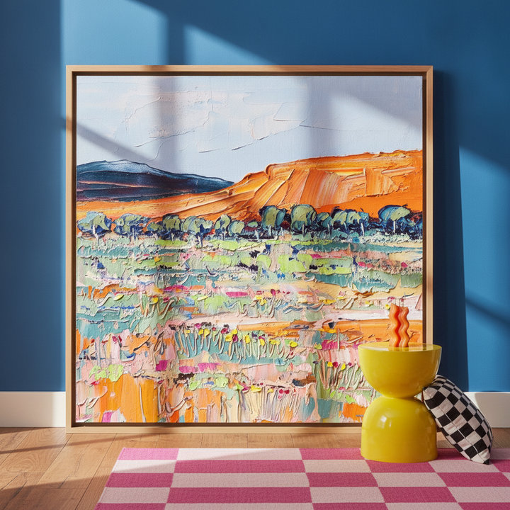 Oversized statement canvas wall art with a natural timber surround leaning against the wall in a colourful eclectic dining room