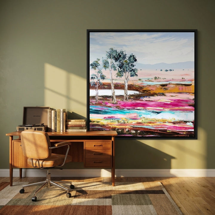Canvas wall art with a black surround styled on the wall in a mid-century home office