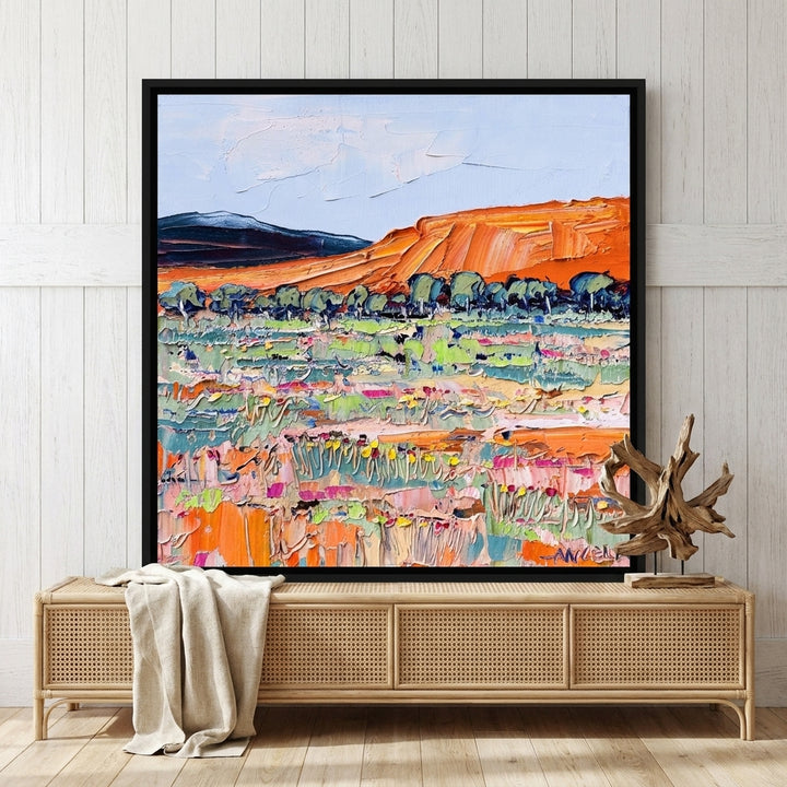 Canvas wall art with a black surround standing on a sideboard in a coastal home office