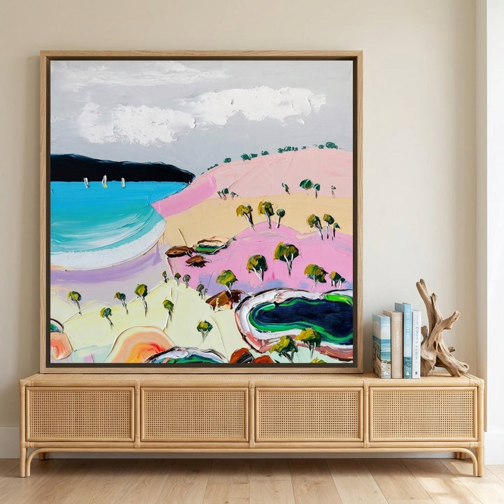 Canvas wall art with a natural timber surround standing on a sideboard in a coastal bedroom