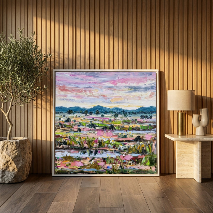 Canvas wall art with a white surround leaning against the wall in a luxe home office