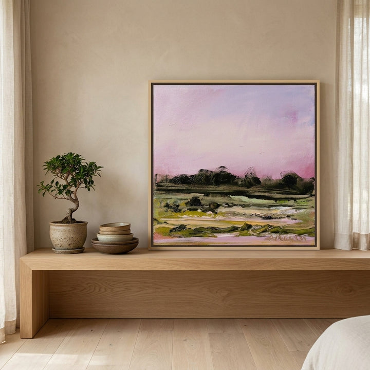 Canvas wall art with a natural timber surround standing on a shelf in a warm Japandi bedroom