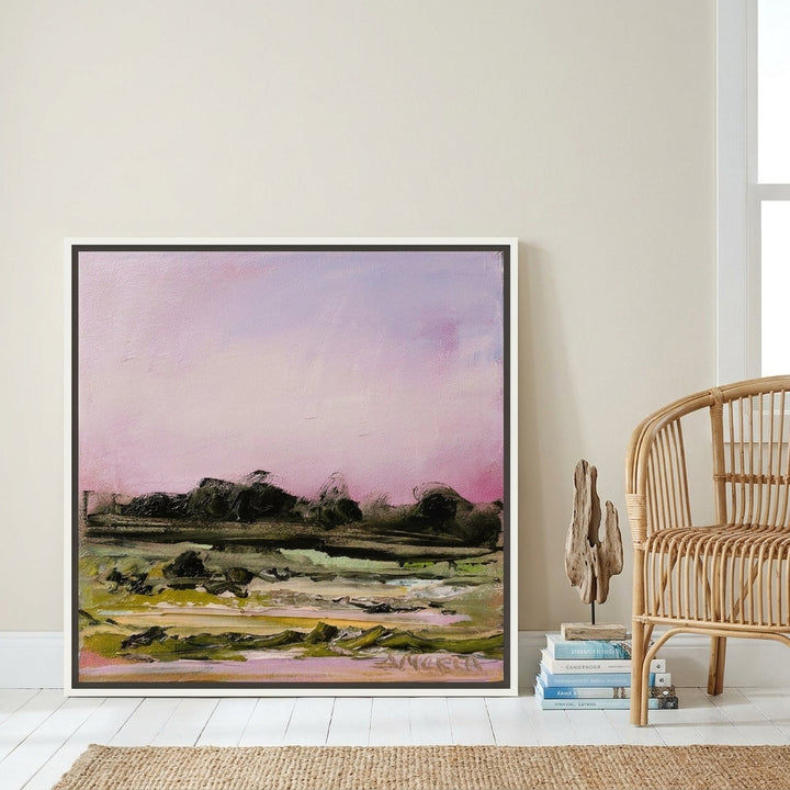 Canvas wall art with a white surround leaning against the wall in a coastal home office