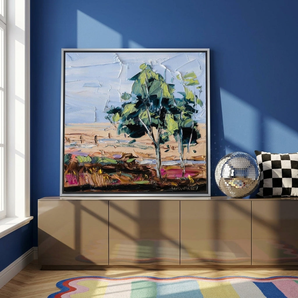 Canvas wall art with a silver leaf surround standing on a sideboard in a colourful eclectic home office
