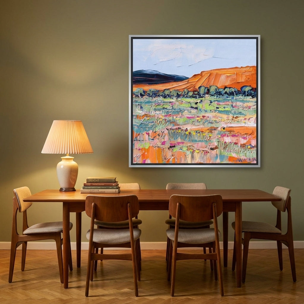 Canvas wall art with a silver leaf surround styled on the wall in a mid-century dining room