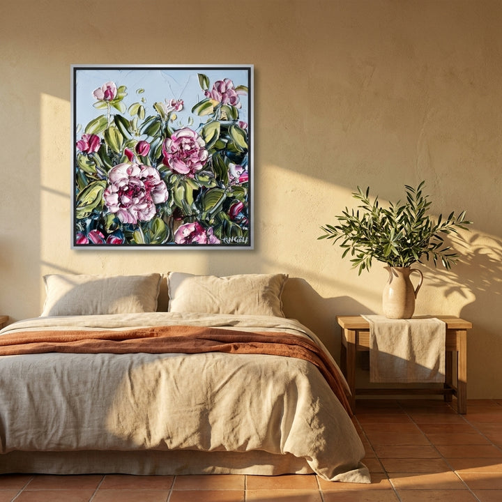 Canvas wall art with a silver leaf surround styled on the wall in a Mediterranean bedroom