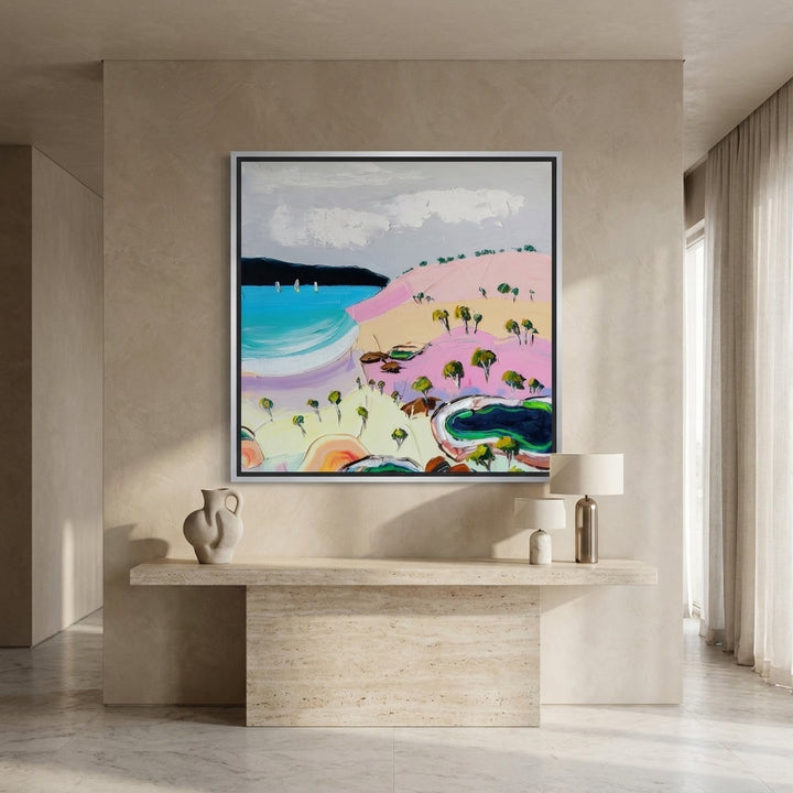 Oversized statement canvas wall art with a silver leaf surround styled on the wall in a luxe living room
