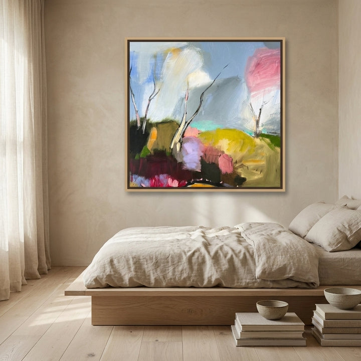 Canvas wall art with a natural timber surround styled on the wall in a warm Japandi bedroom