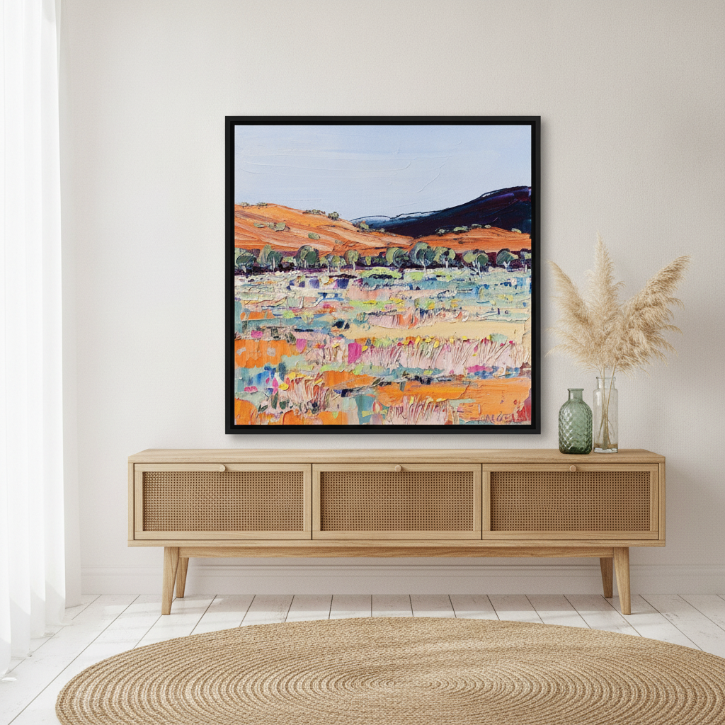 Canvas wall art with a black surround standing on a sideboard in a coastal bedroom