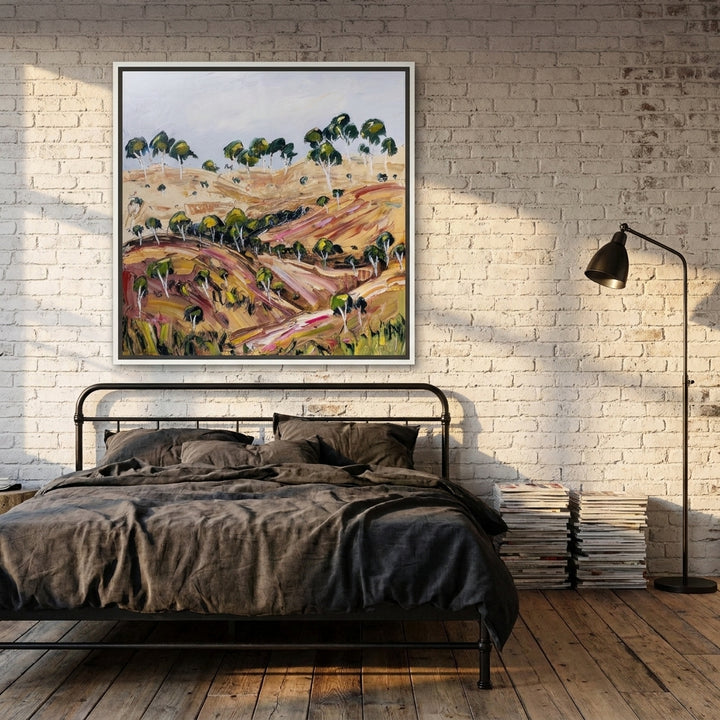 Canvas wall art with a white surround styled on the wall in an industrial loft bedroom
