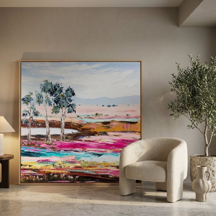 Oversized statement canvas wall art with a natural timber surround leaning against the wall in a luxe dining room