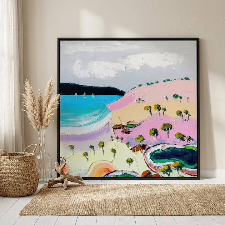 Oversized statement canvas wall art with a black surround leaning against the wall in a coastal living room