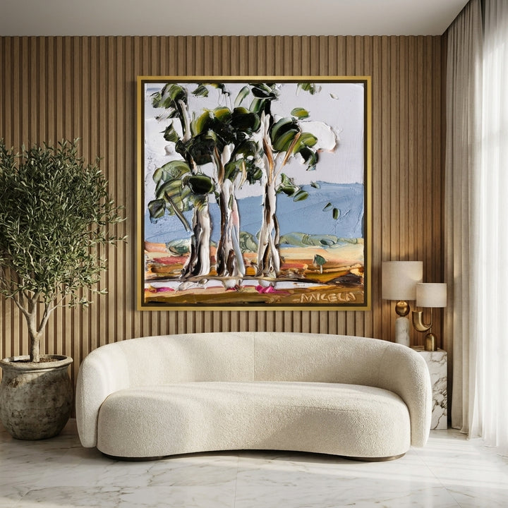 Oversized statement canvas wall art with a gold leaf surround styled on the wall in a luxe living room