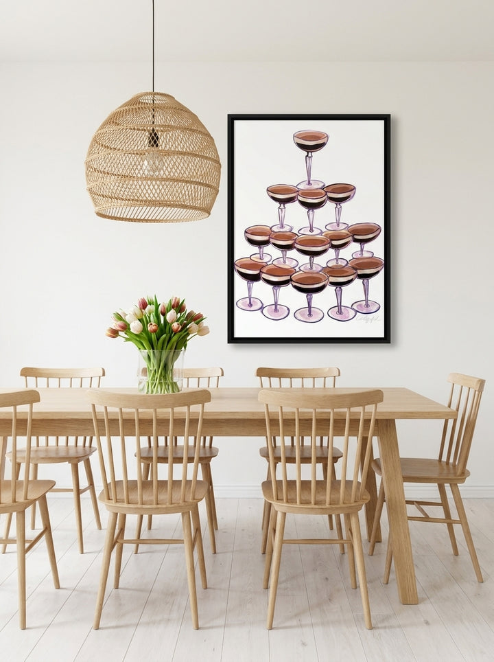 Canvas wall art with a black surround styled on the wall in a bright Scandinavian dining room