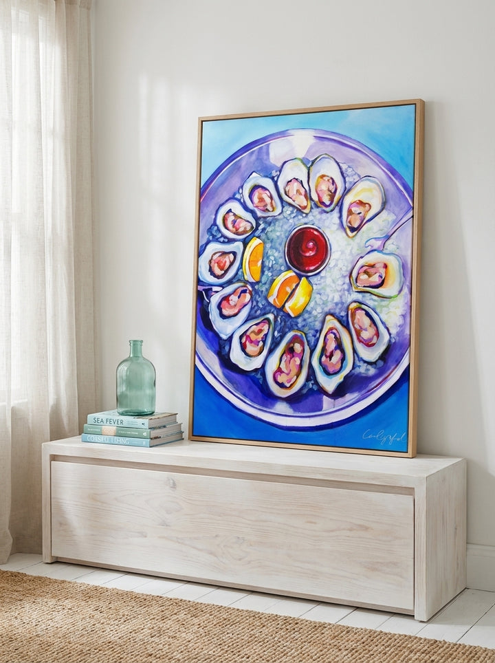 Modern wall art print standing on a console in a coastal living room