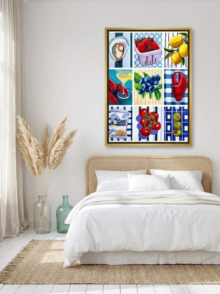Canvas wall art with a gold leaf surround styled on the wall in a coastal bedroom