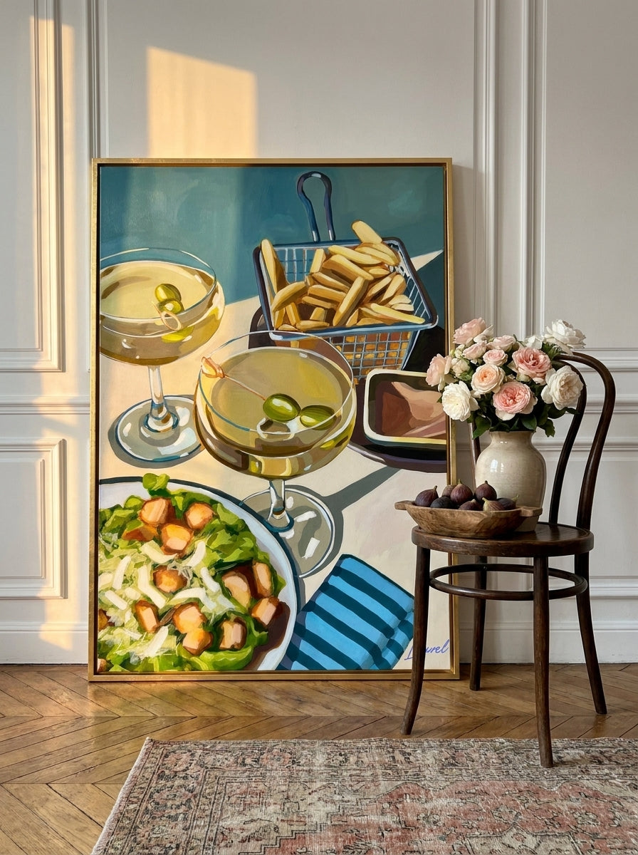Oversized statement canvas wall art with a gold leaf surround leaning against the wall in a Parisian living room