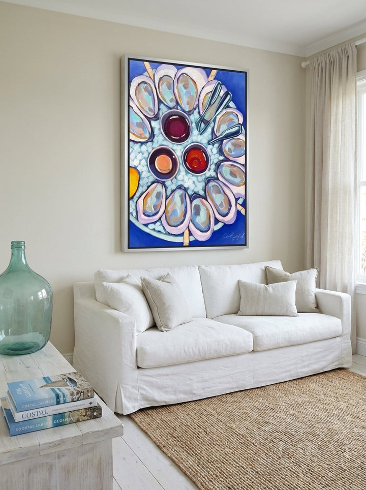 Canvas wall art with a silver leaf surround styled on the wall in a coastal living room