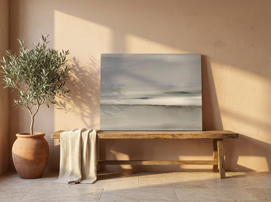 Stretched canvas wall art standing on a bench in a Mediterranean bedroom