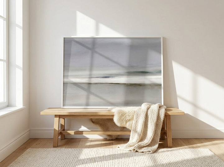 Modern wall art print standing on a bench in a bright Scandinavian home office