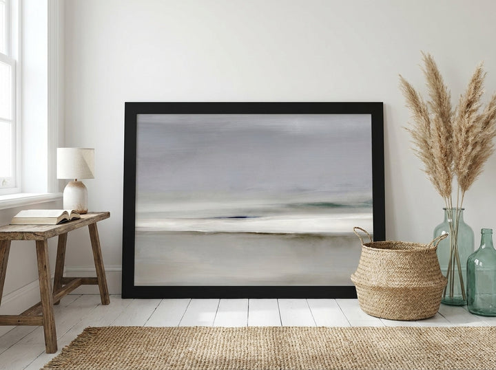 Modern wall art print leaning against the wall in a coastal bedroom