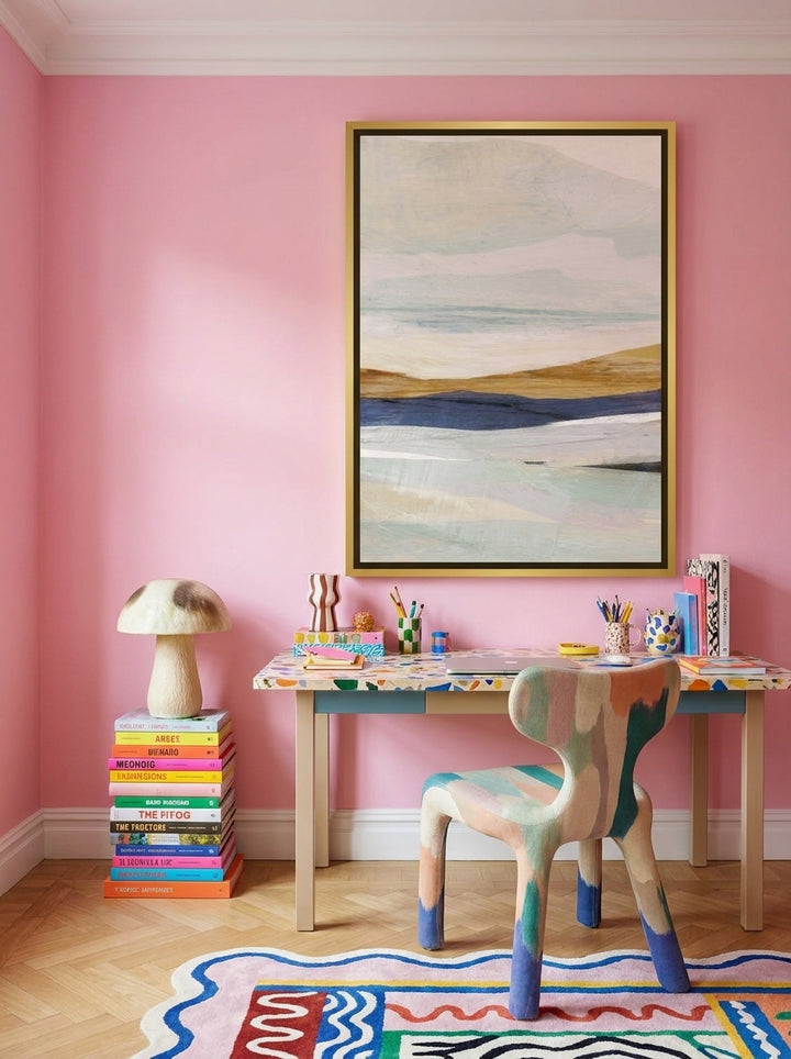 Canvas wall art with a gold leaf surround styled on the wall in a colourful eclectic home office