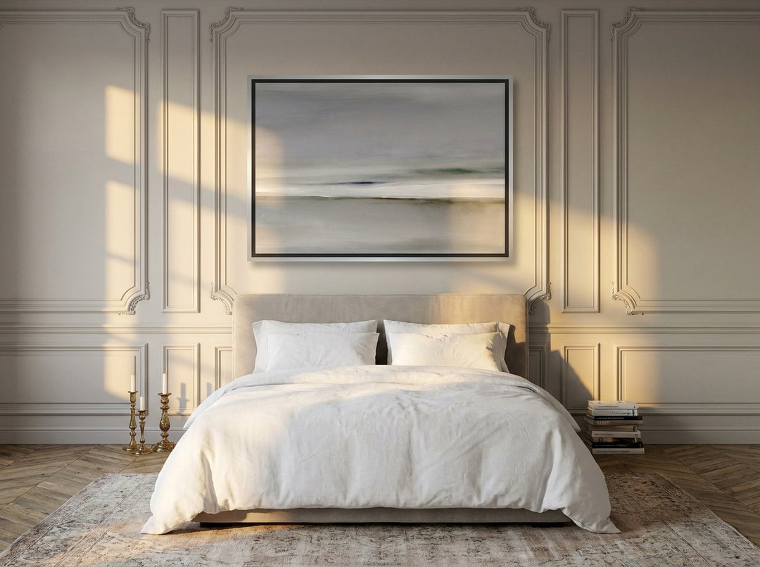 Canvas wall art with a silver leaf surround styled on the wall in a Parisian bedroom