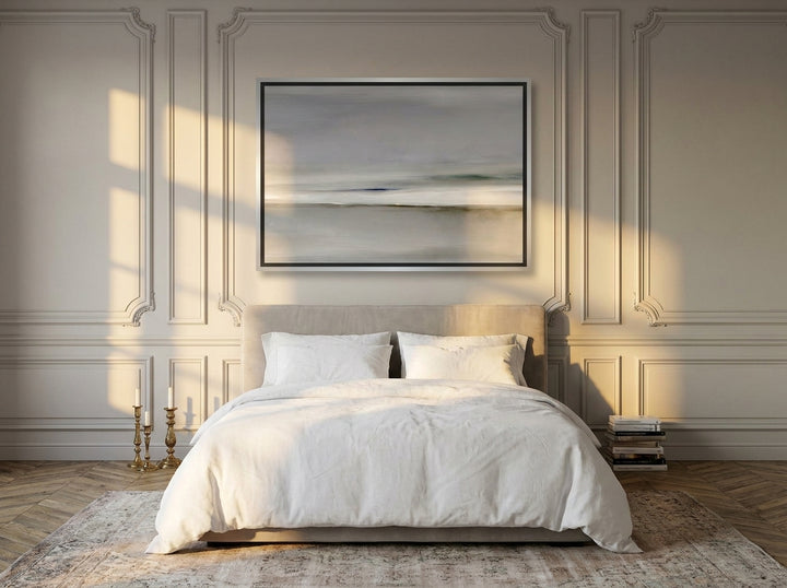 Canvas wall art with a silver leaf surround styled on the wall in a Parisian bedroom