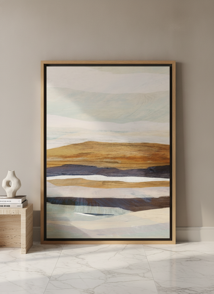 Oversized statement canvas wall art with a natural timber surround leaning against the wall in a luxe bedroom