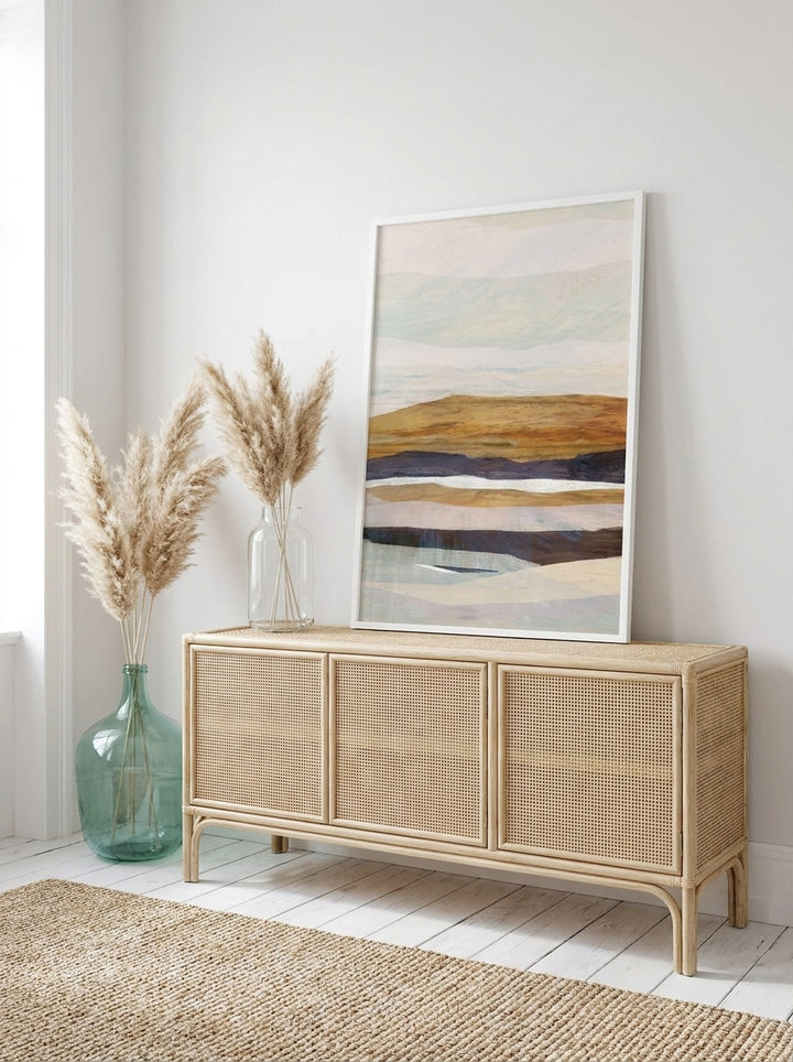 Modern wall art print standing on a sideboard in a coastal bedroom