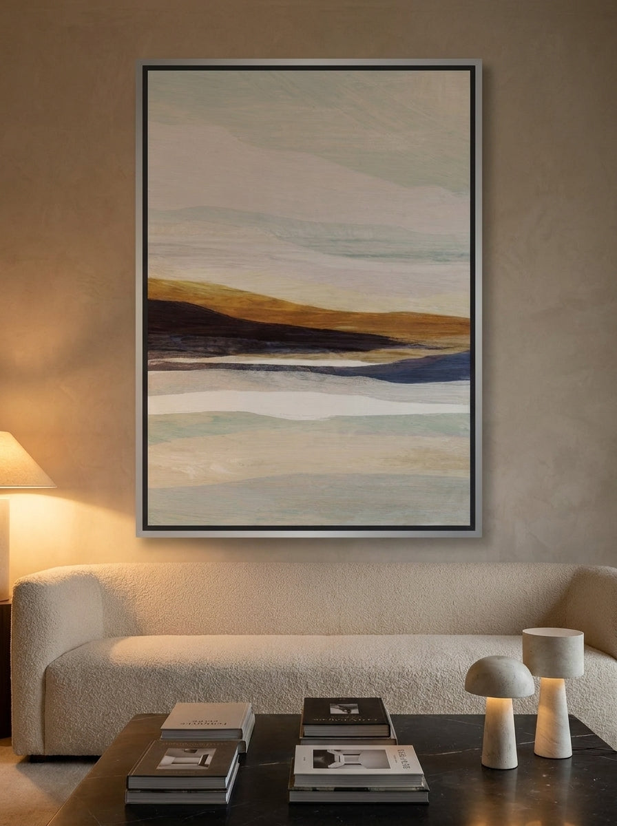 Oversized statement canvas wall art with a silver leaf surround styled on the wall in a luxe living room