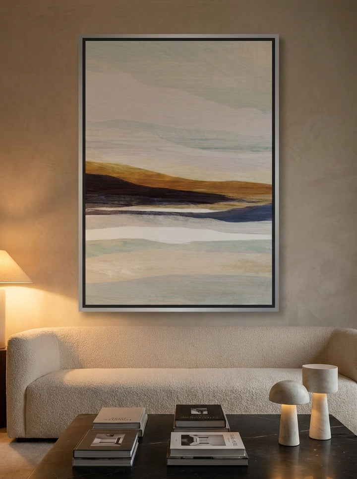 Oversized statement canvas wall art with a silver leaf surround styled on the wall in a luxe living room
