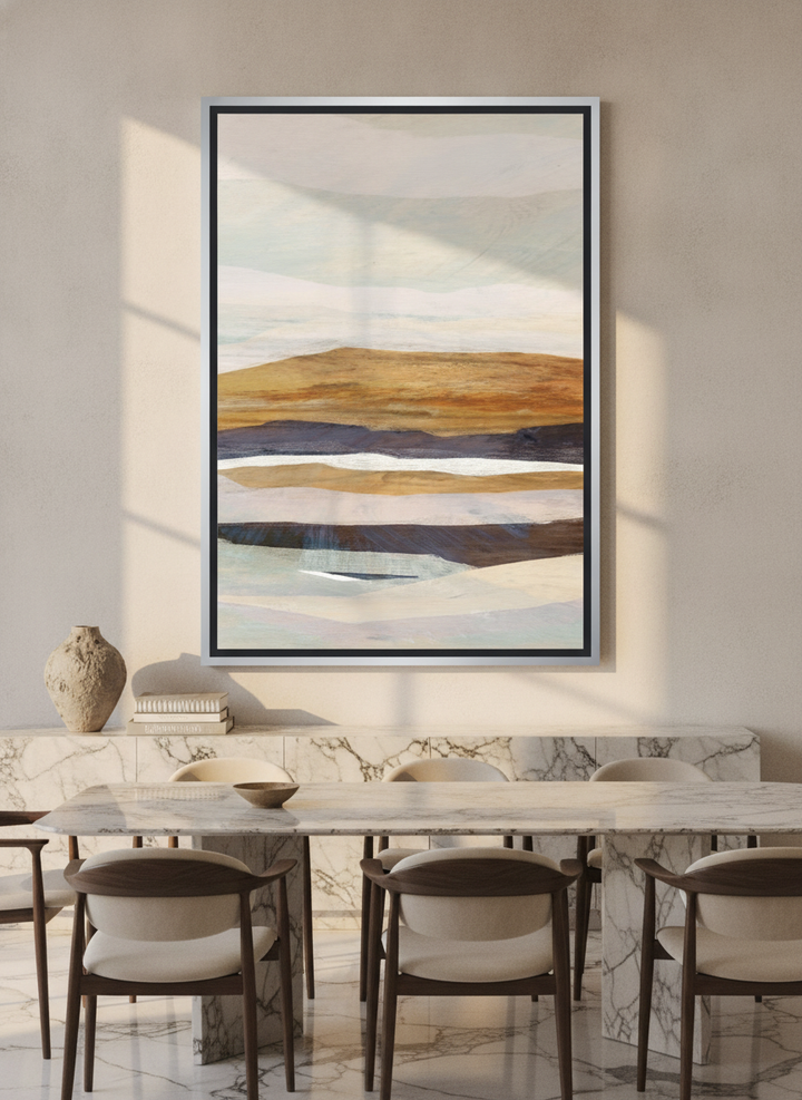 Oversized statement canvas wall art with a silver leaf surround styled on the wall in a luxe dining room