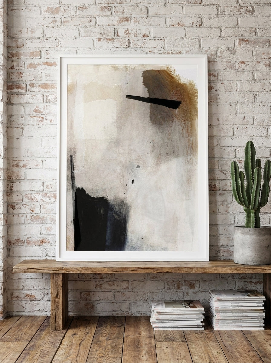 Modern wall art print standing on a bench in an industrial loft bedroom