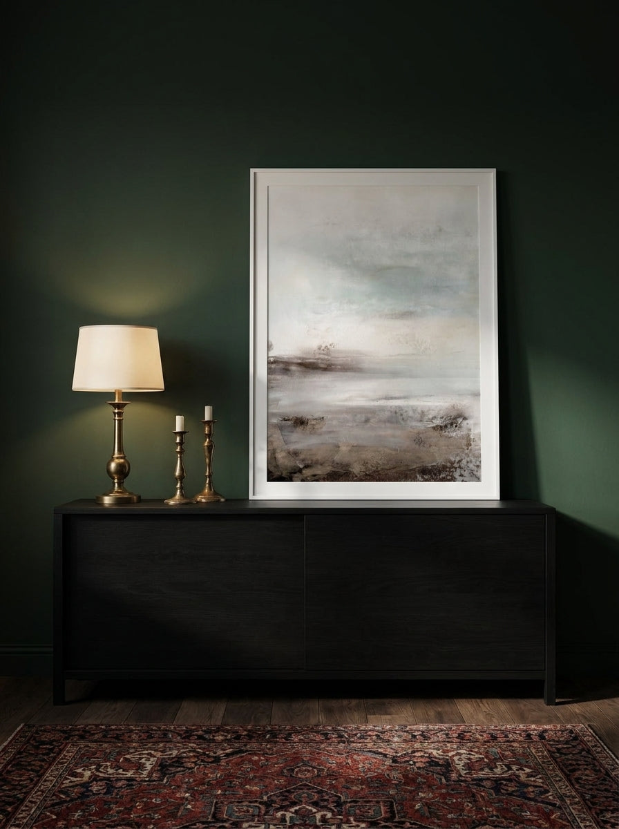 Modern wall art print standing on a console in a moody bedroom