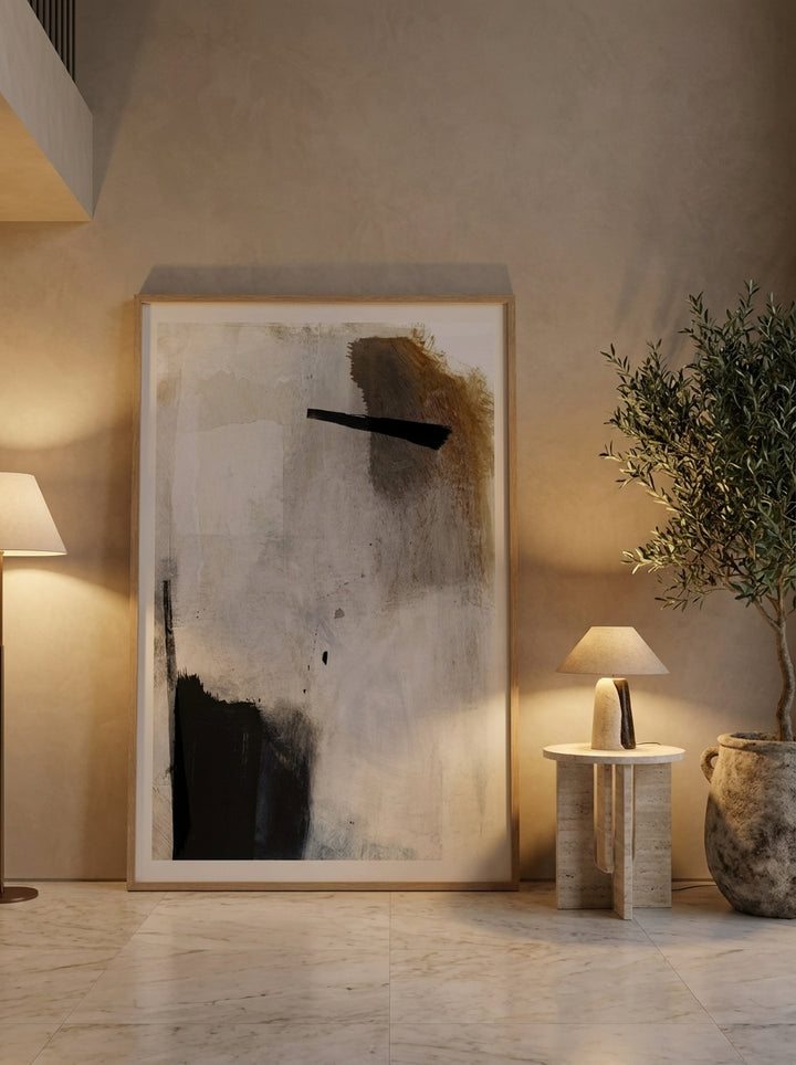 Oversized statement modern wall art print leaning against the wall in a luxe living room