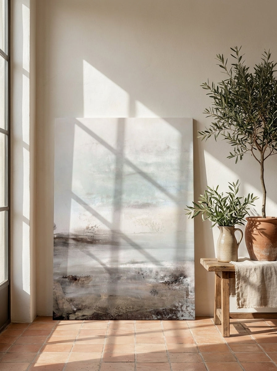 Stretched canvas wall art leaning against the wall in a Mediterranean home office
