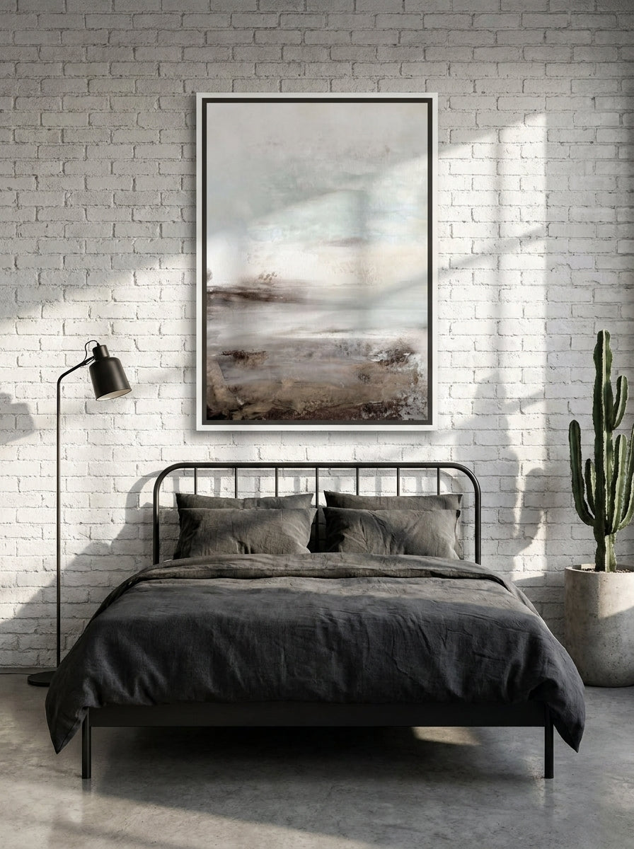Canvas wall art with a white surround styled on the wall in an industrial loft bedroom