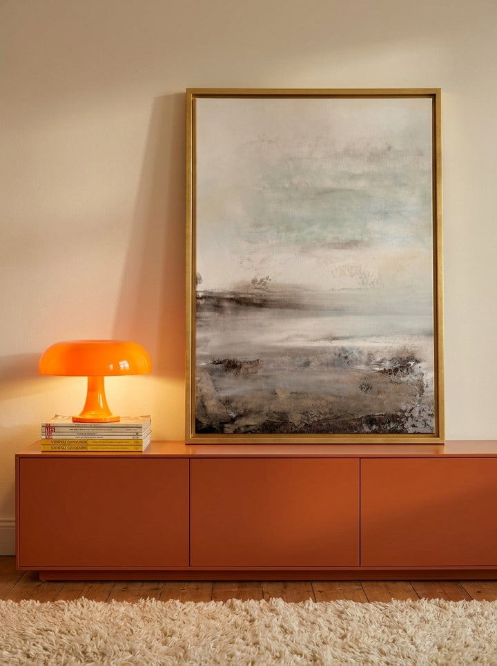 Canvas wall art with a gold leaf surround standing on a sideboard in a retro 70s home office