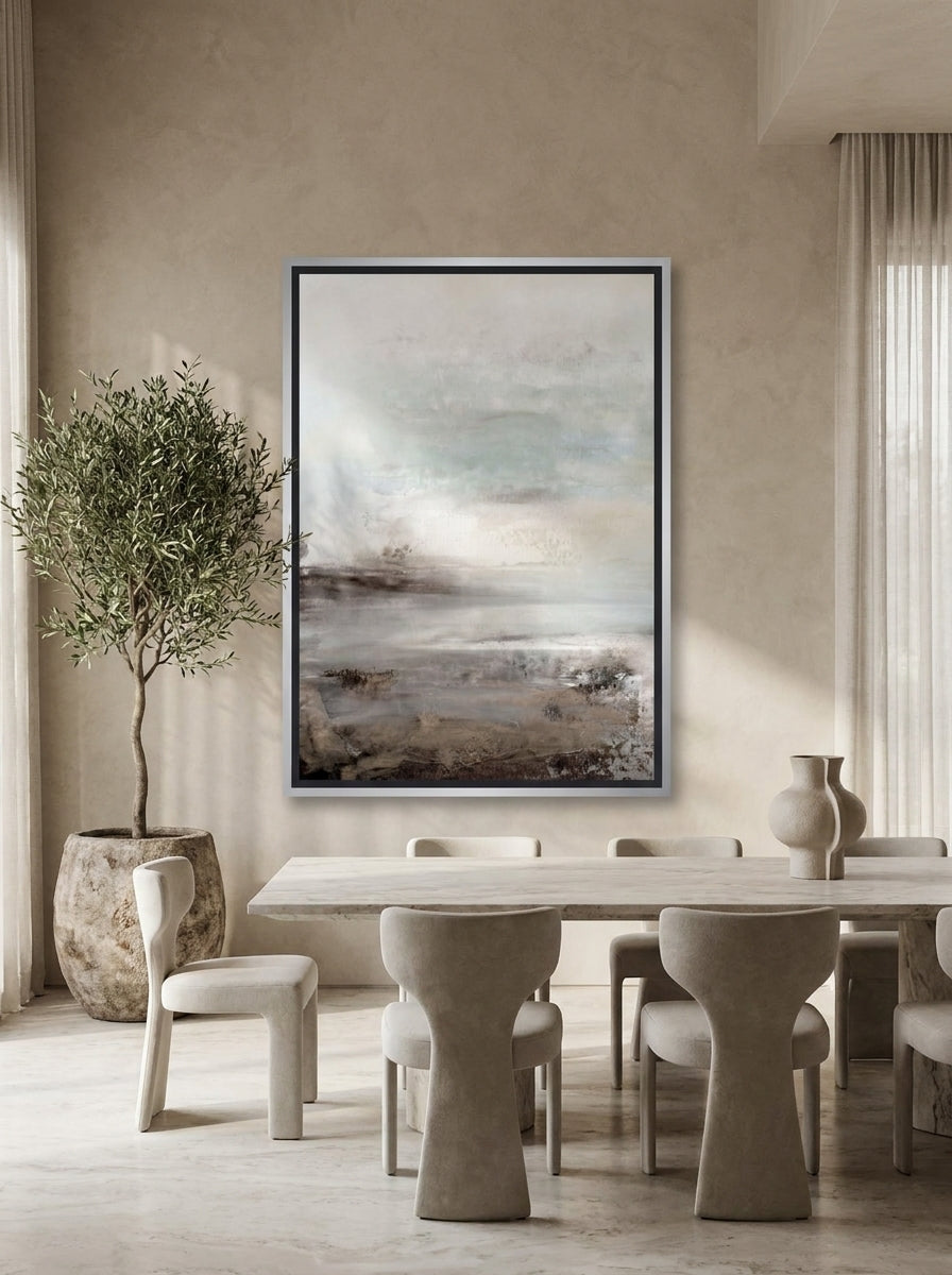 Oversized statement canvas wall art with a silver leaf surround styled on the wall in a luxe dining room