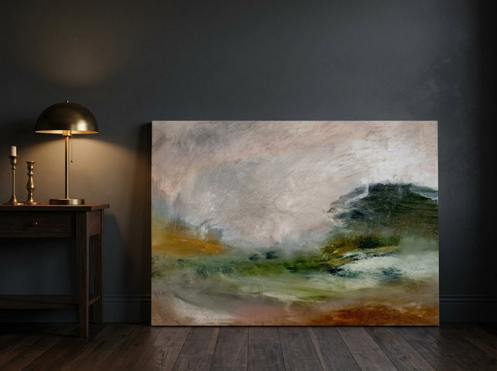 Stretched canvas wall art leaning against the wall in a moody home office