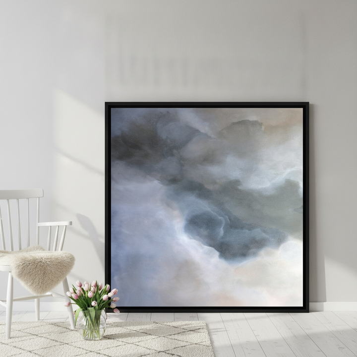 Canvas wall art with a black surround leaning against the wall in a bright Scandinavian home office