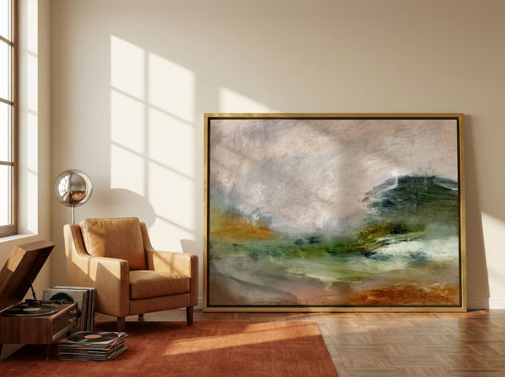 Oversized statement canvas wall art with a gold leaf surround leaning against the wall in a retro 70s living room